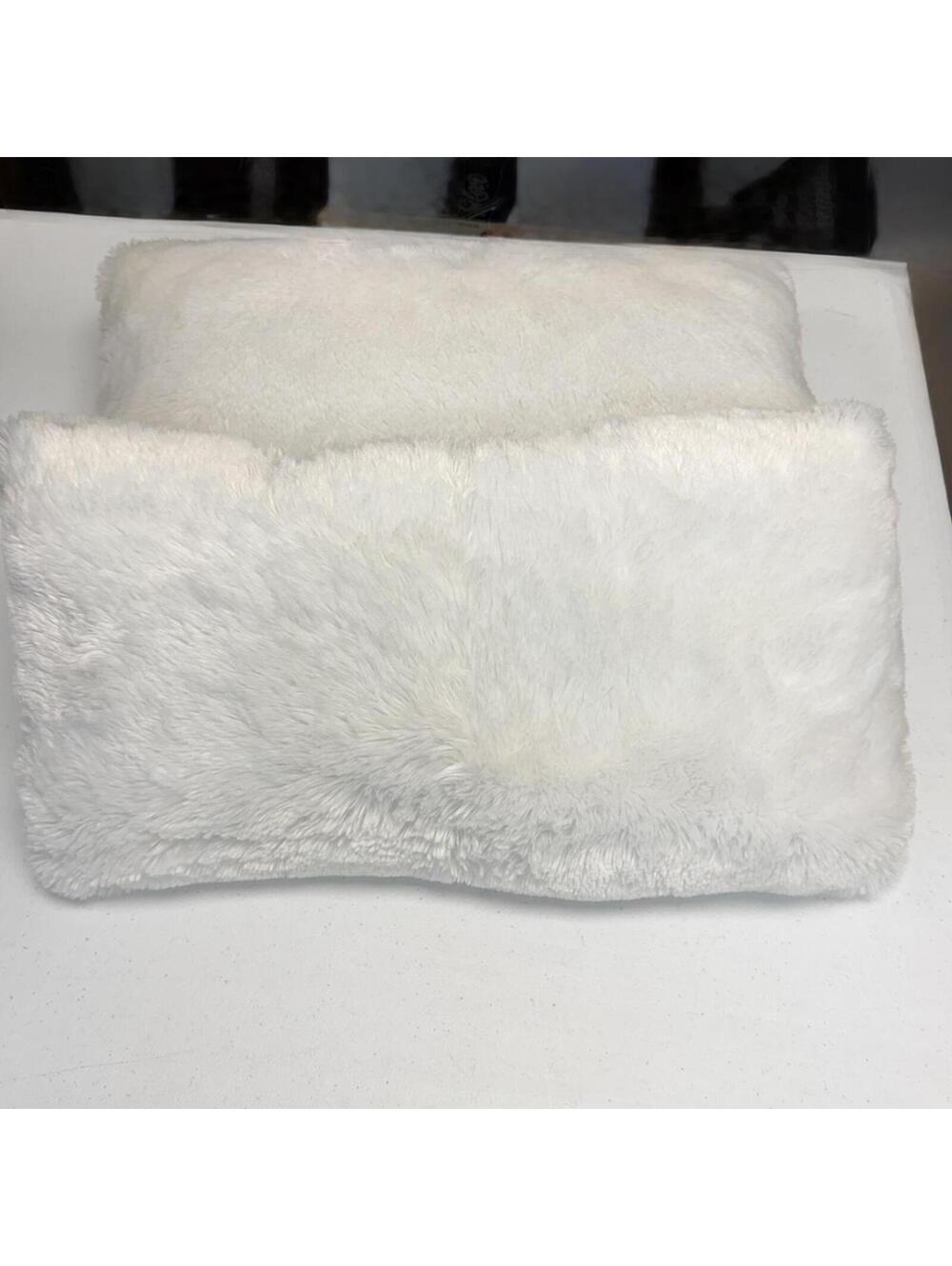 White faux fur throw pillows.